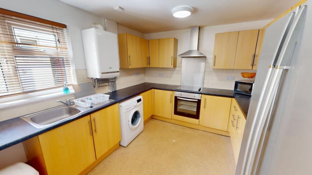 A spacious and well-maintained kitchen featurin...