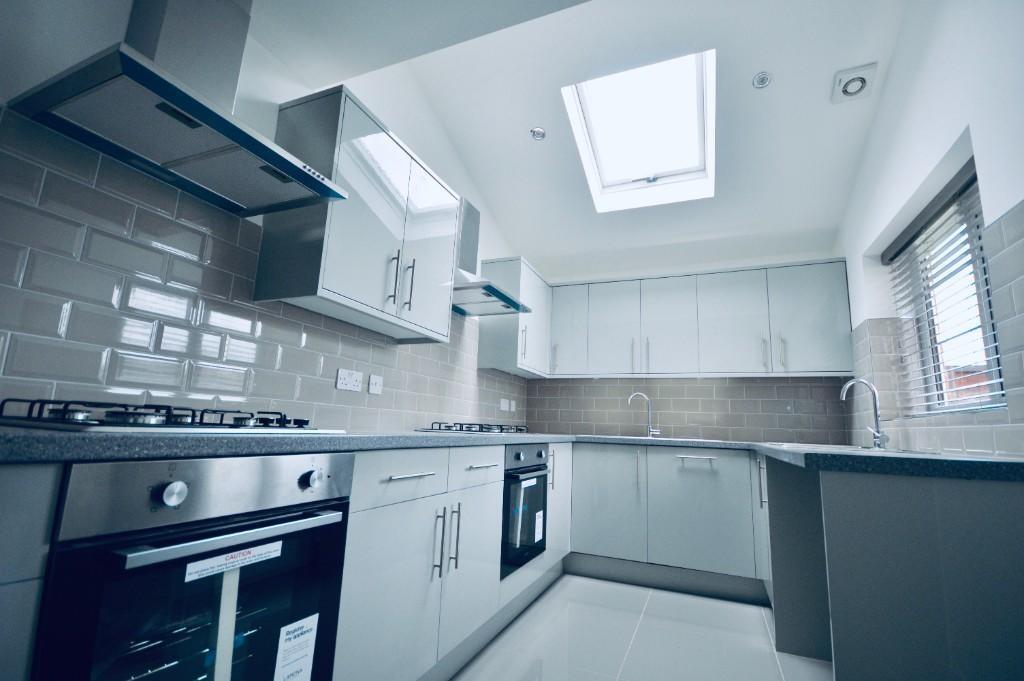 This spacious kitchen features modern appliance...