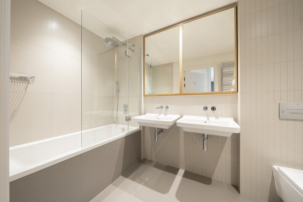 Experience elegance in this chic modern bathroom, designed for ultimate comfort.