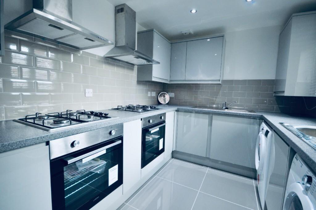 A modern and spacious kitchen featuring sleek c...