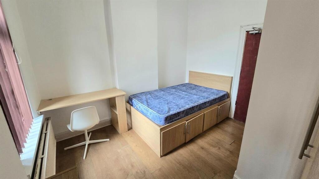 Bright, simply furnished bedroom with a raised ...