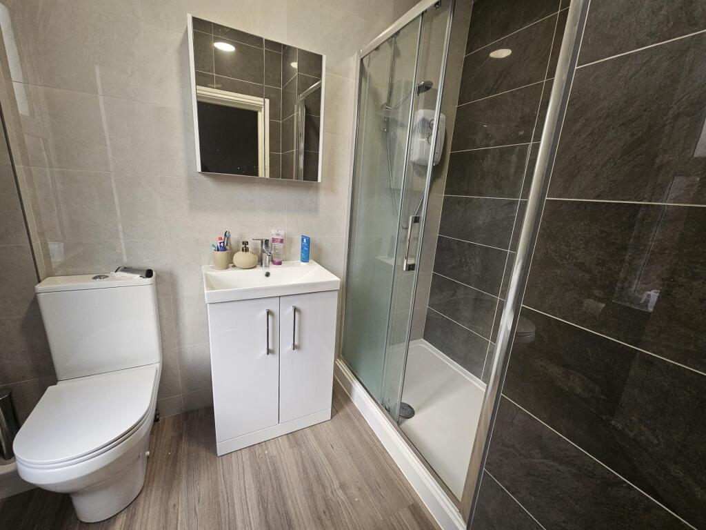 Bright and modern bathroom featuring a spacious...