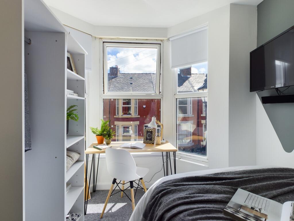 A bright and inviting double bedroom with a stu...