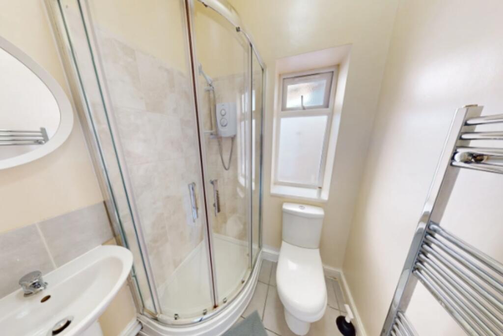 A modern bathroom featuring a sleek shower unit...
