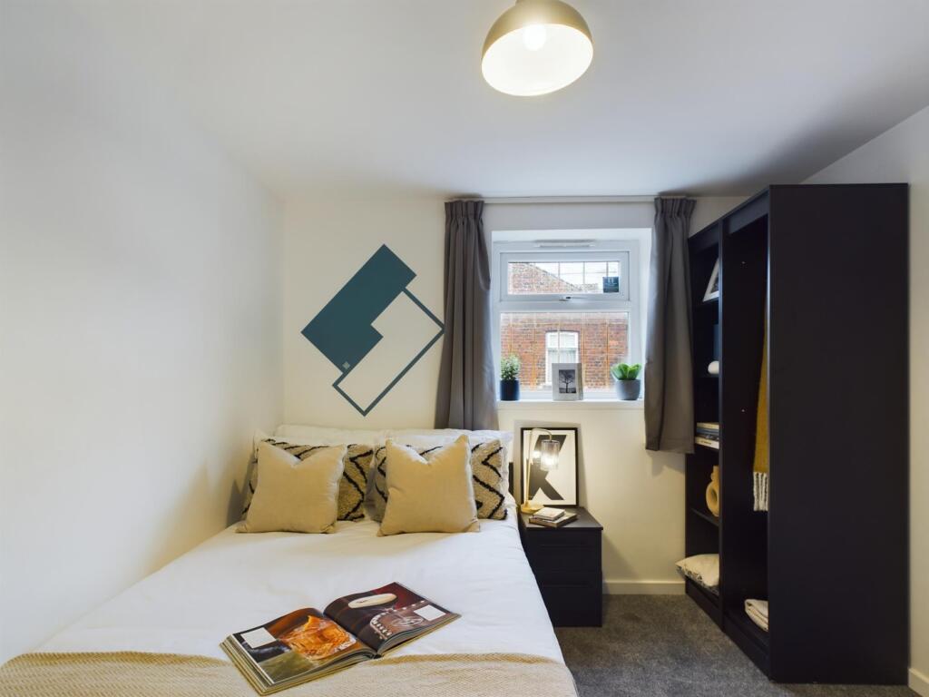 A bright and inviting double bedroom featuring ...