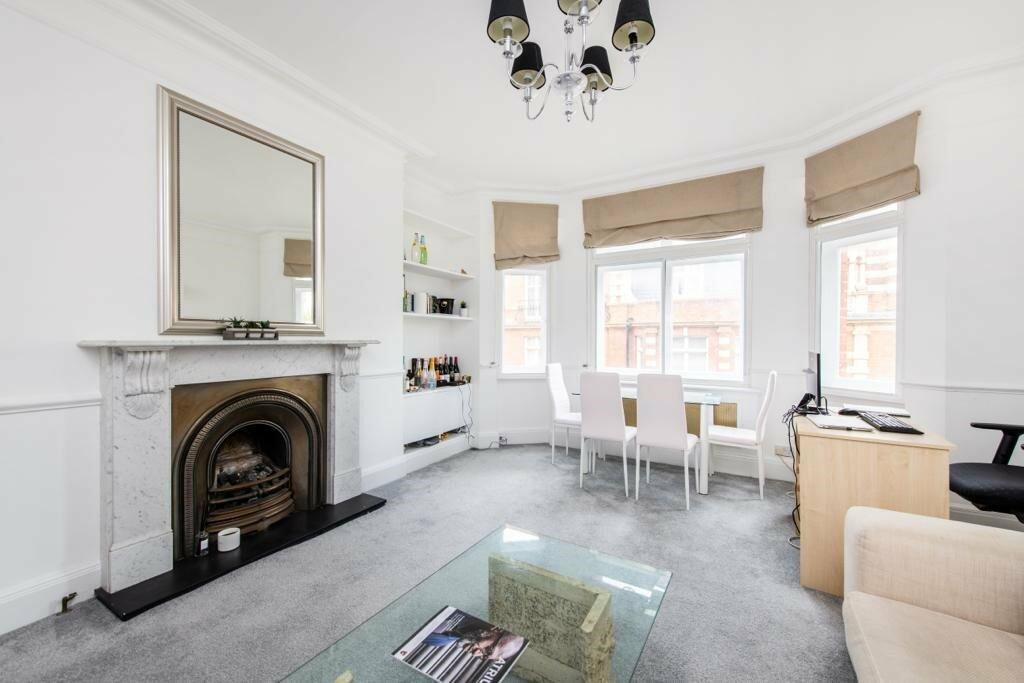 High ceilings &amp; period fireplace in reception room