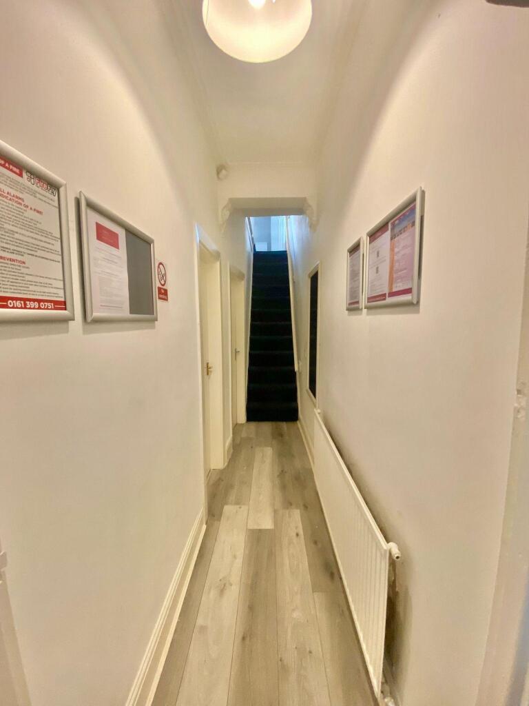 Bright and tidy hallway with light wooden floor...