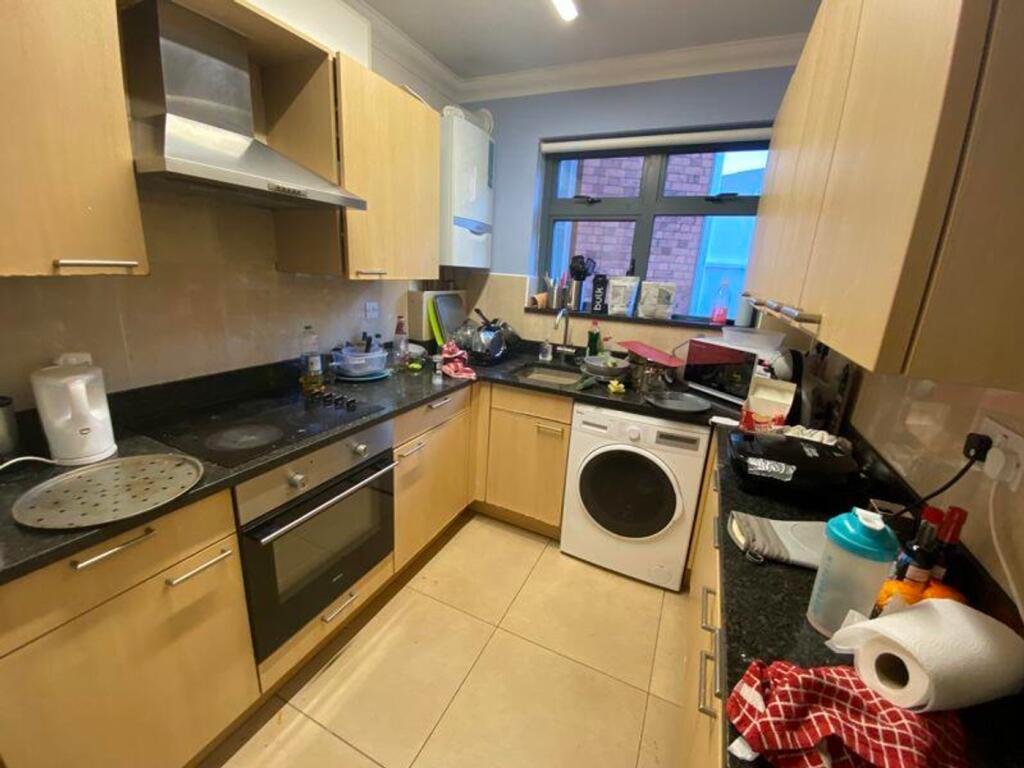A cozy kitchen with ample storage and natural l...