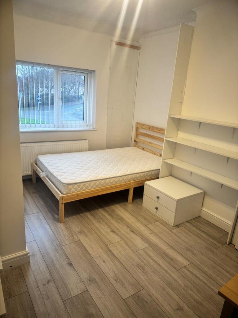 A bright and tidy double bedroom featuring a sp...