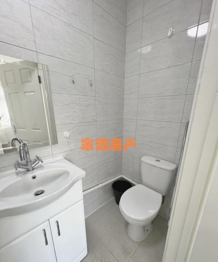 A clean and modern small bathroom featuring a w...