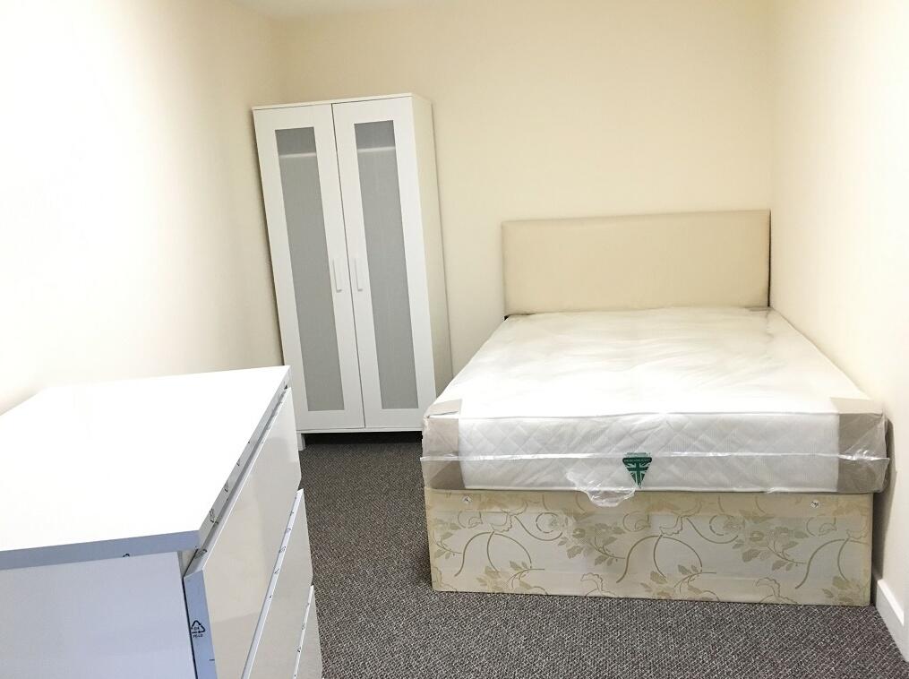 A neat and bright single bedroom featuring a co...