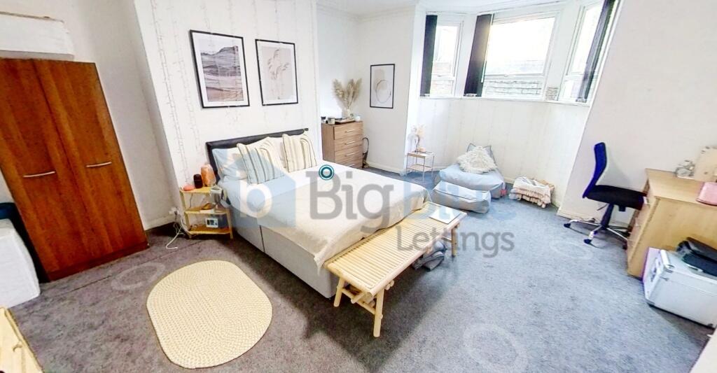 Bright and spacious master bedroom featuring a ...