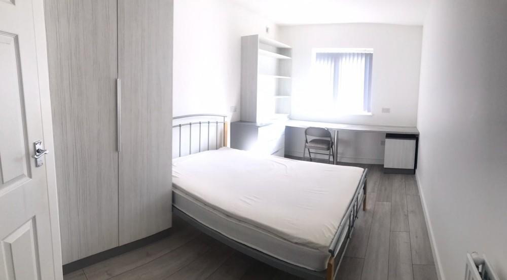 A bright and tidy double bedroom featuring a co...