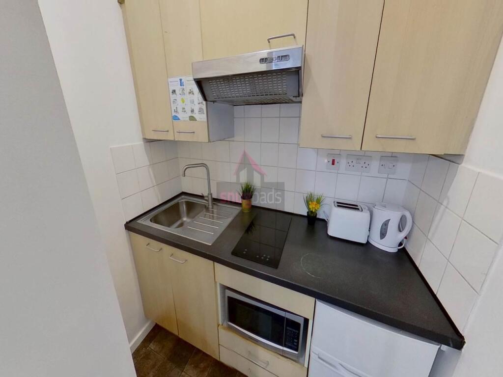 Compact and efficient kitchen space featuring m...