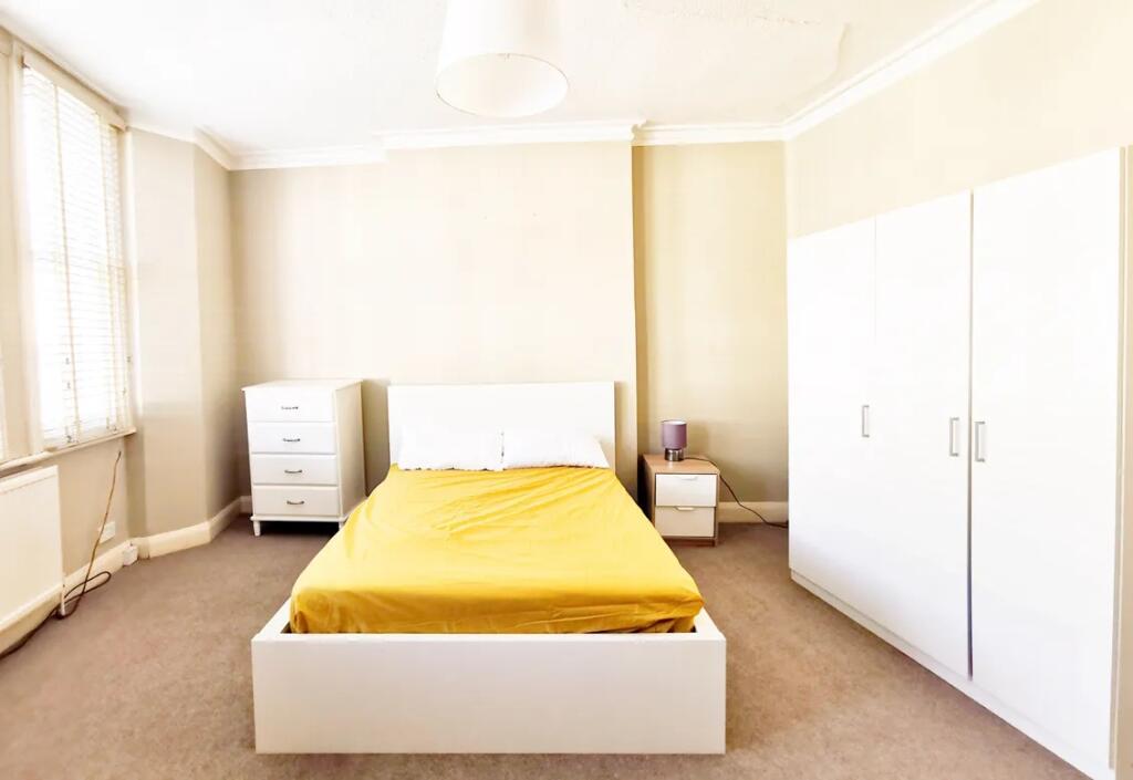 Bright and spacious double bedroom featuring a ...