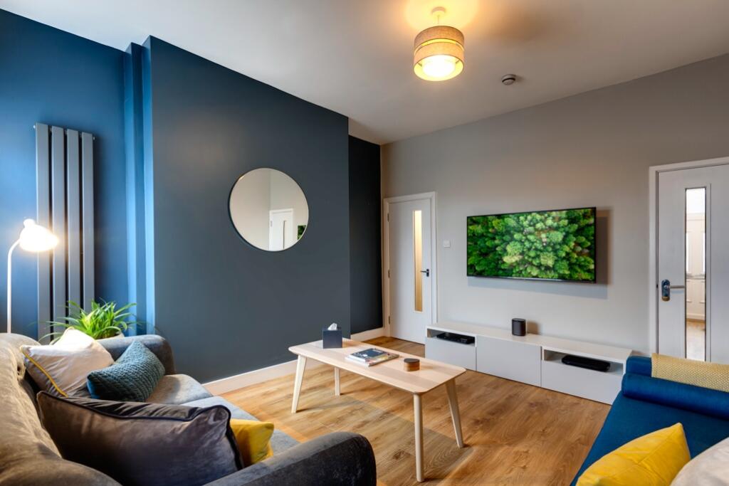 Modern, well-lit living room featuring stylish ...