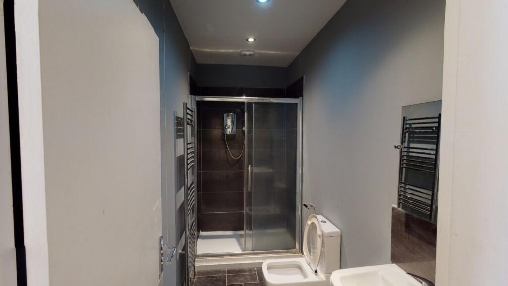 A modern and well-maintained bathroom suite fea...