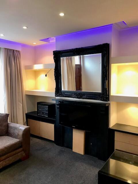 Contemporary living room featuring stylish blac...