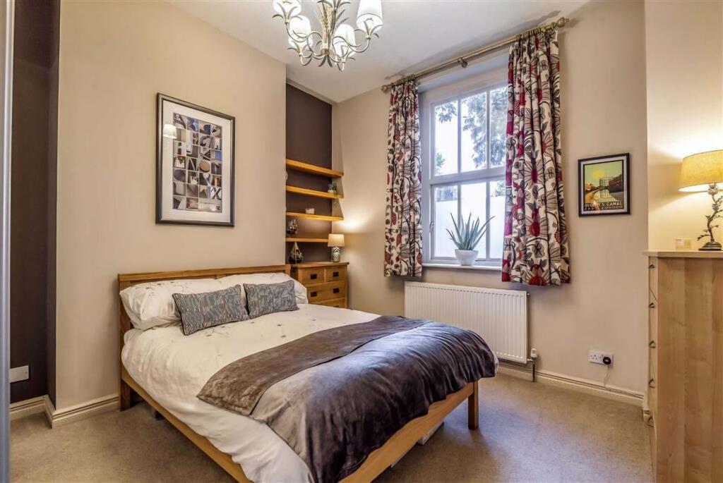 A bright and inviting master bedroom with a lar...