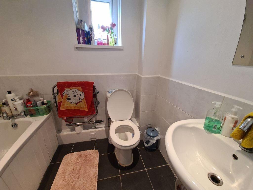 A clean and practical bathroom featuring a whit...