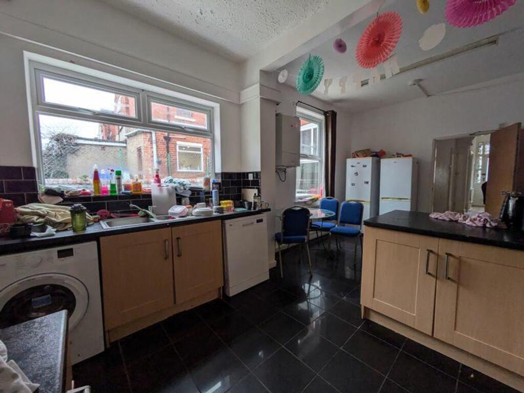 A spacious kitchen with ample storage and natur...