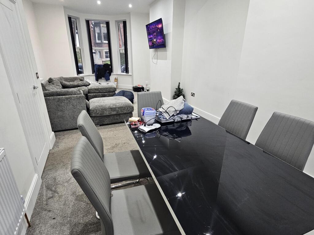 A modern, well-lit living room featuring comfor...