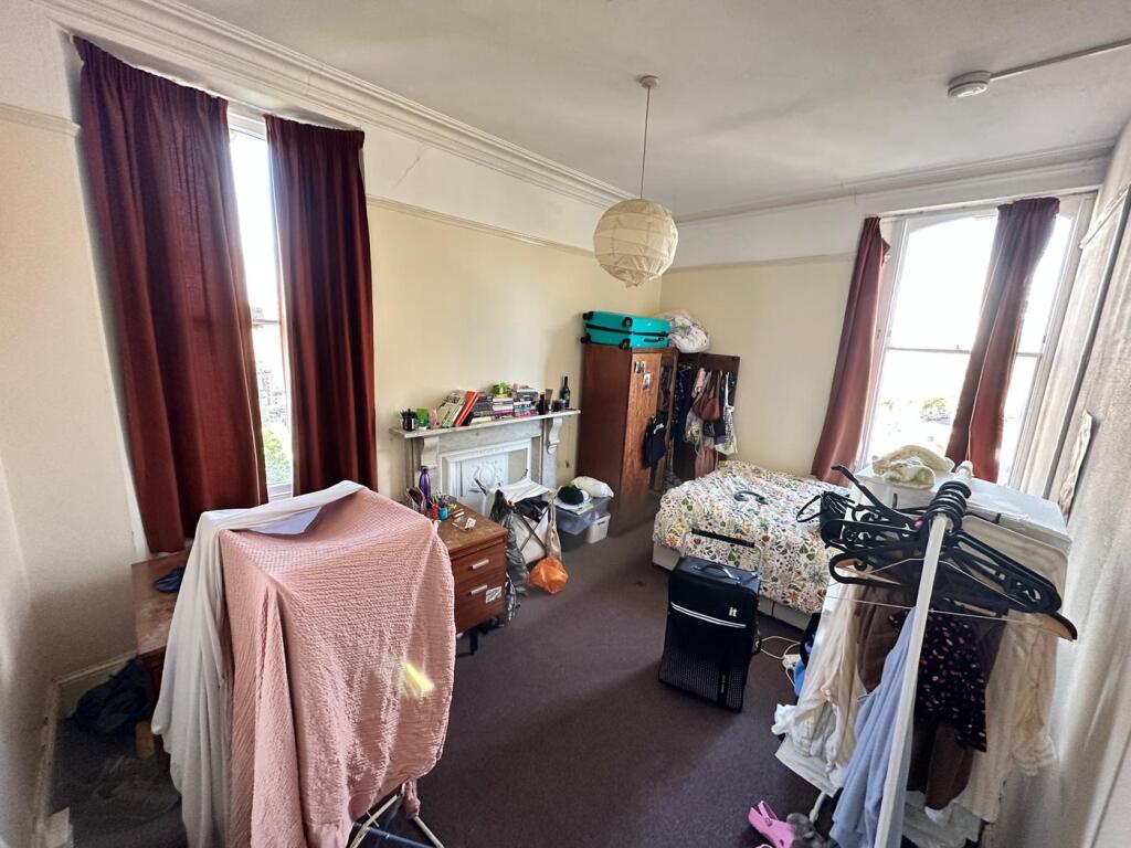 A cozy double bedroom featuring ample natural l...