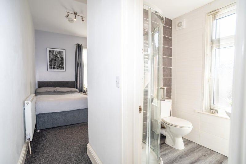 Bright and tidy double bedroom featuring a comf...