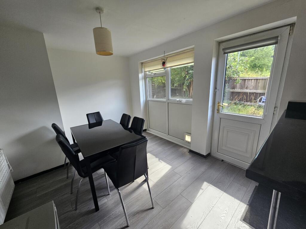 Bright and spacious living area with large wind...
