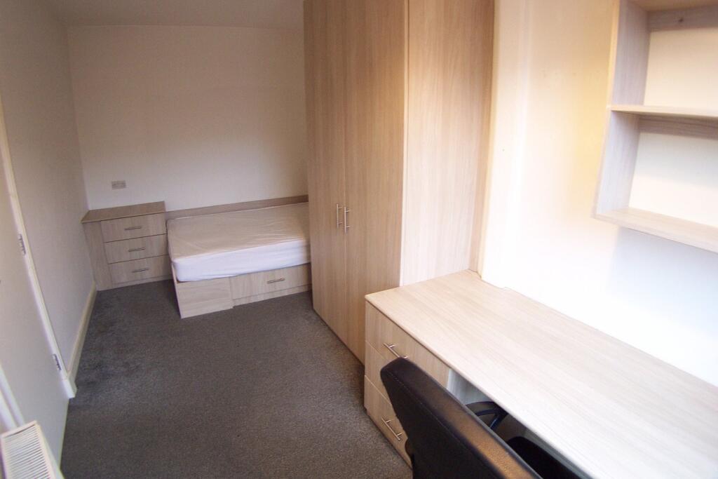 A small, clean restroom featuring a toilet and ...