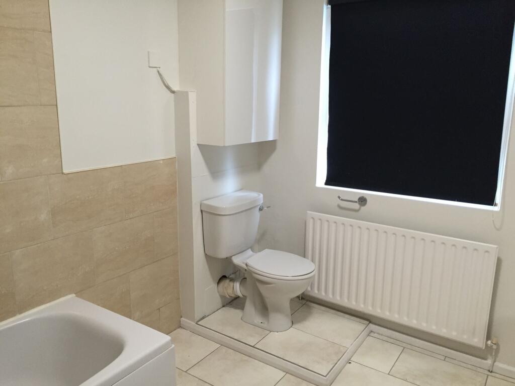 A clean and functional bathroom with a toilet, ...