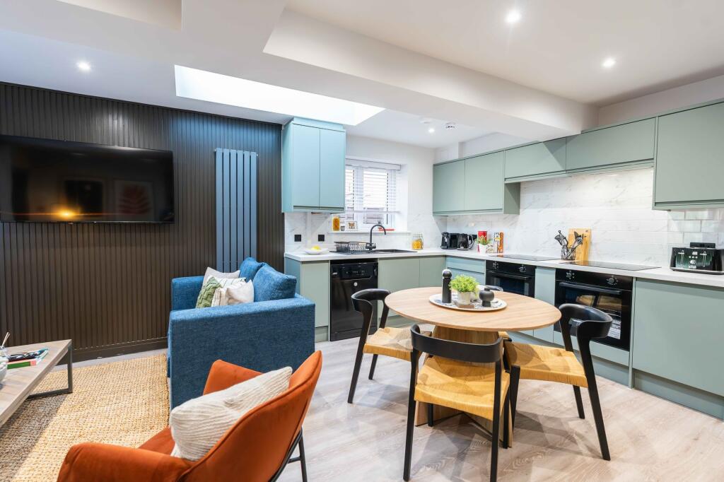 Bright and modern kitchen featuring sleek mint ...