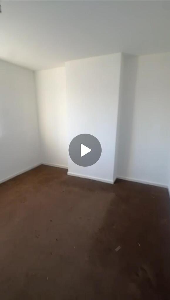 A bright, well-maintained bedroom with white wa...