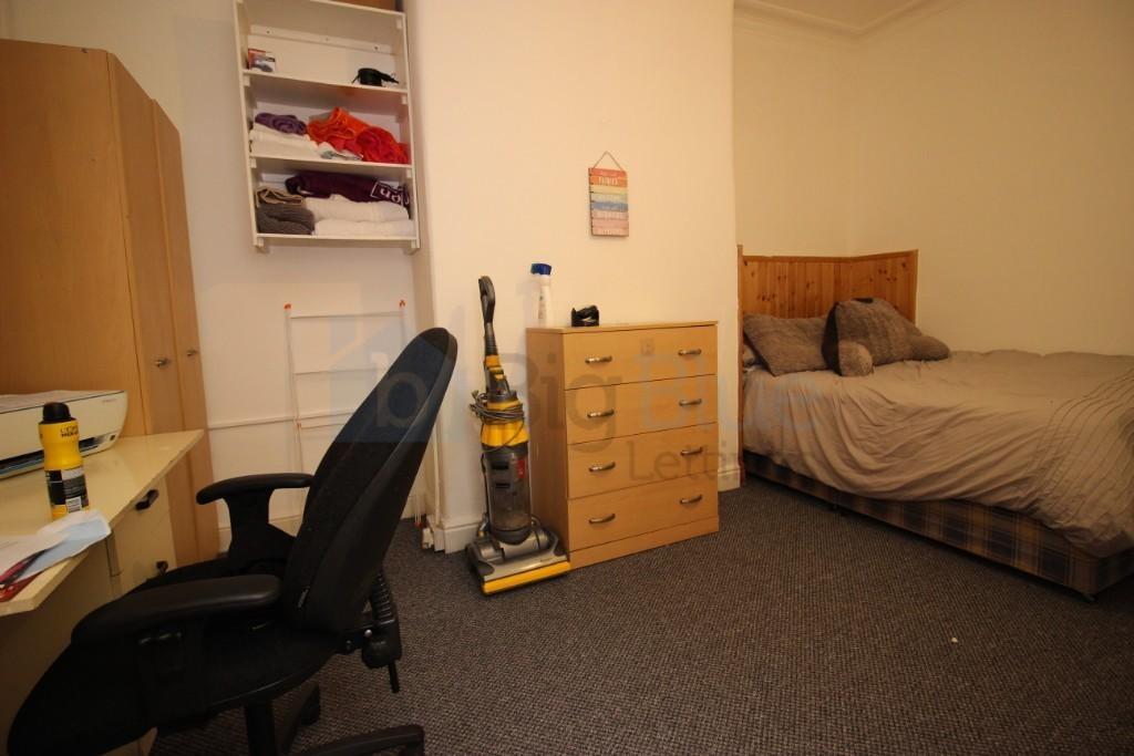 Cozy and functional single bedroom featuring a ...