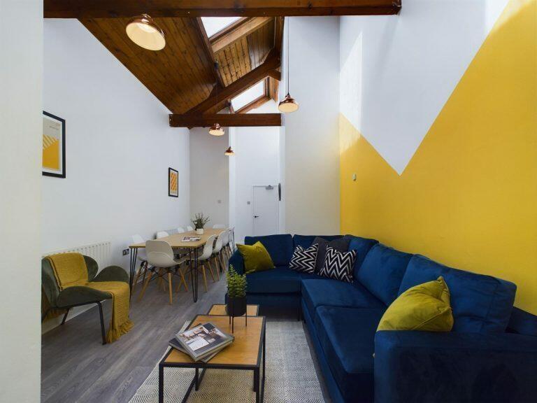 A bright and stylish living room featuring a sp...