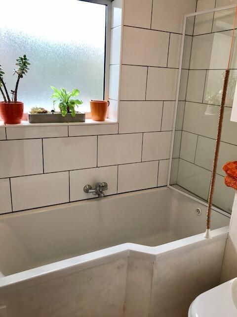 Bright and modern bathroom suite featuring a sp...