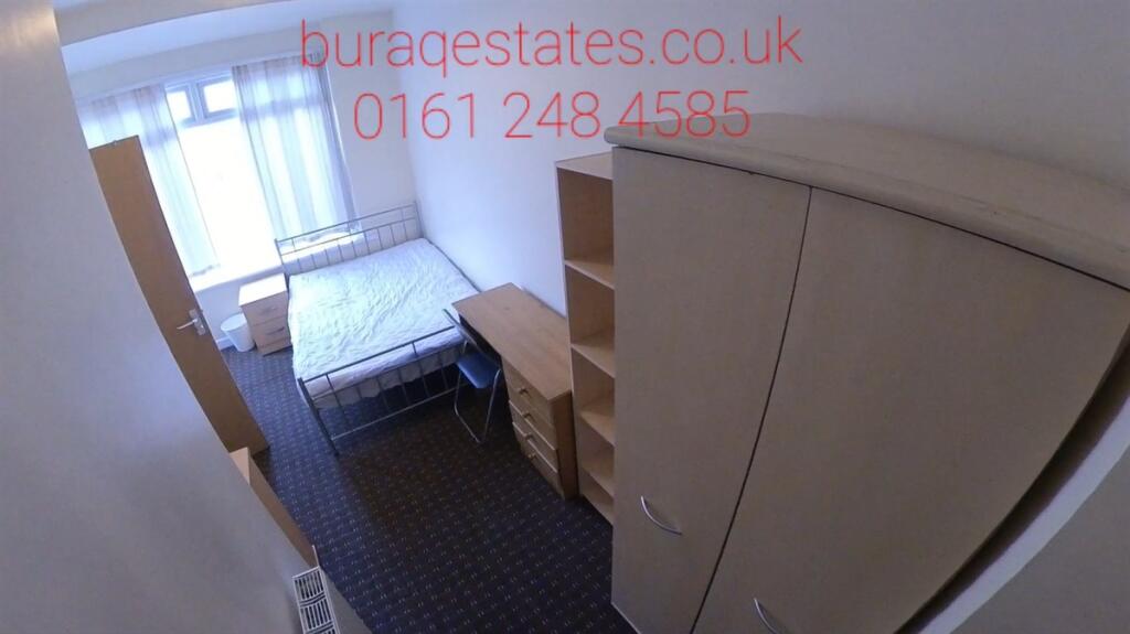 A compact, well-organized bedroom featuring a s...