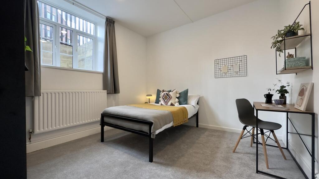A bright and inviting double bedroom featuring ...