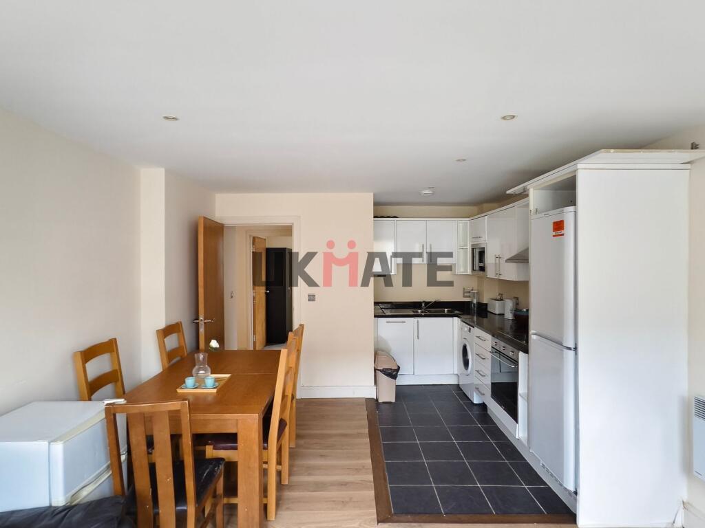 Bright and tidy kitchen area featuring modern w...