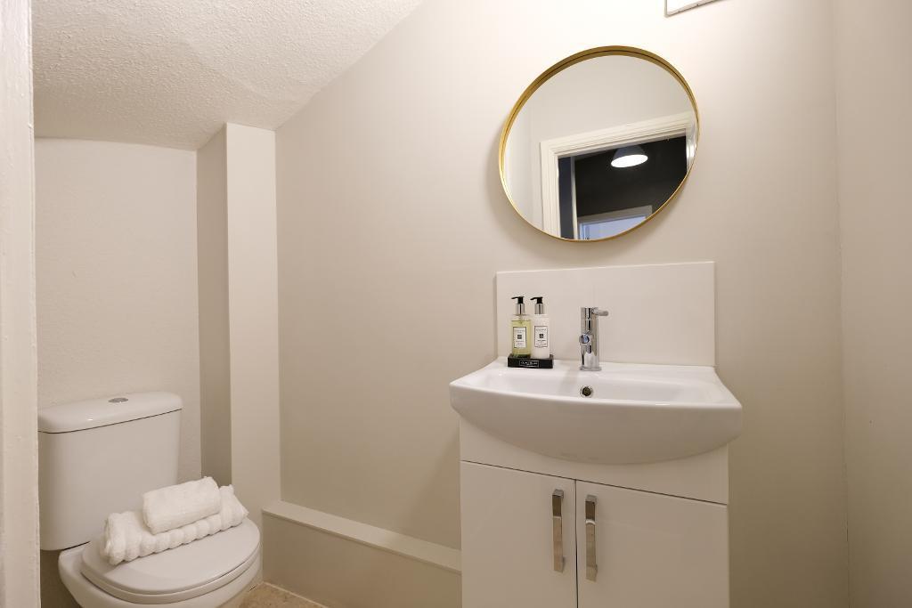 Cloakroom with under stairs storage