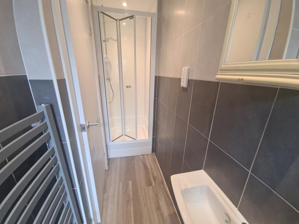 A modern bathroom featuring a sleek shower cubi...