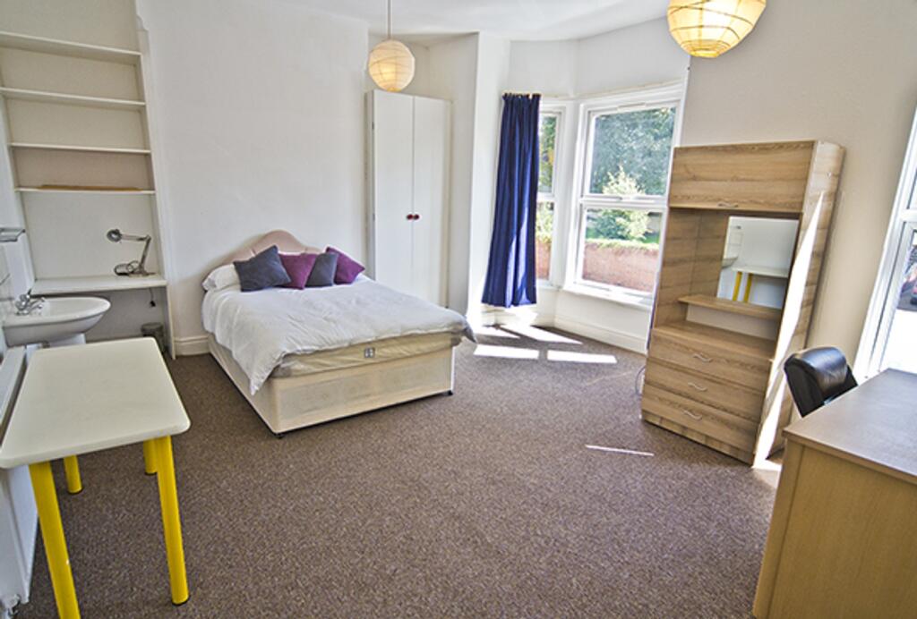 A bright and spacious double bedroom featuring ...