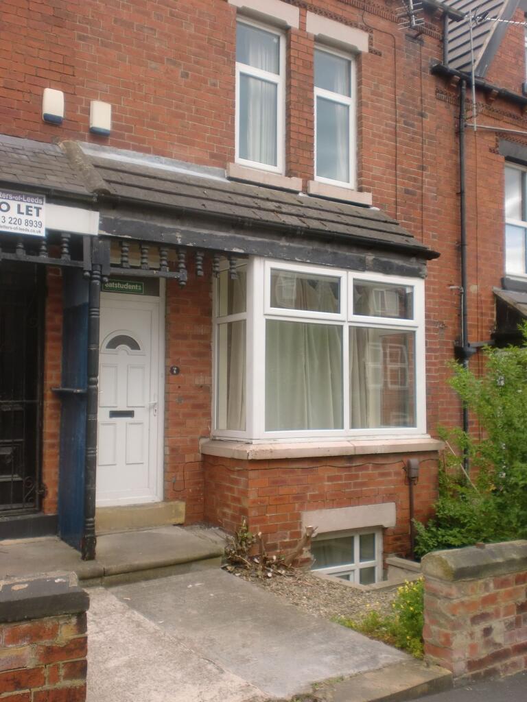Brick-fronted terraced house with a bay window,...