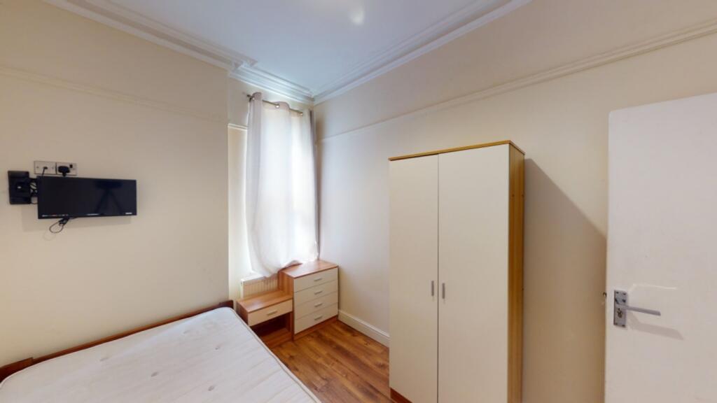 A bright and tidy double bedroom featuring ampl...