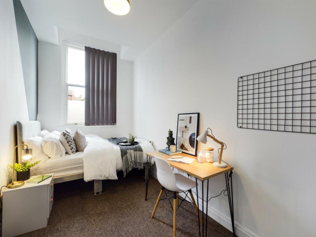 A bright and inviting double bedroom featuring ...
