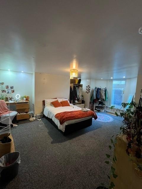 A spacious and inviting master bedroom featurin...