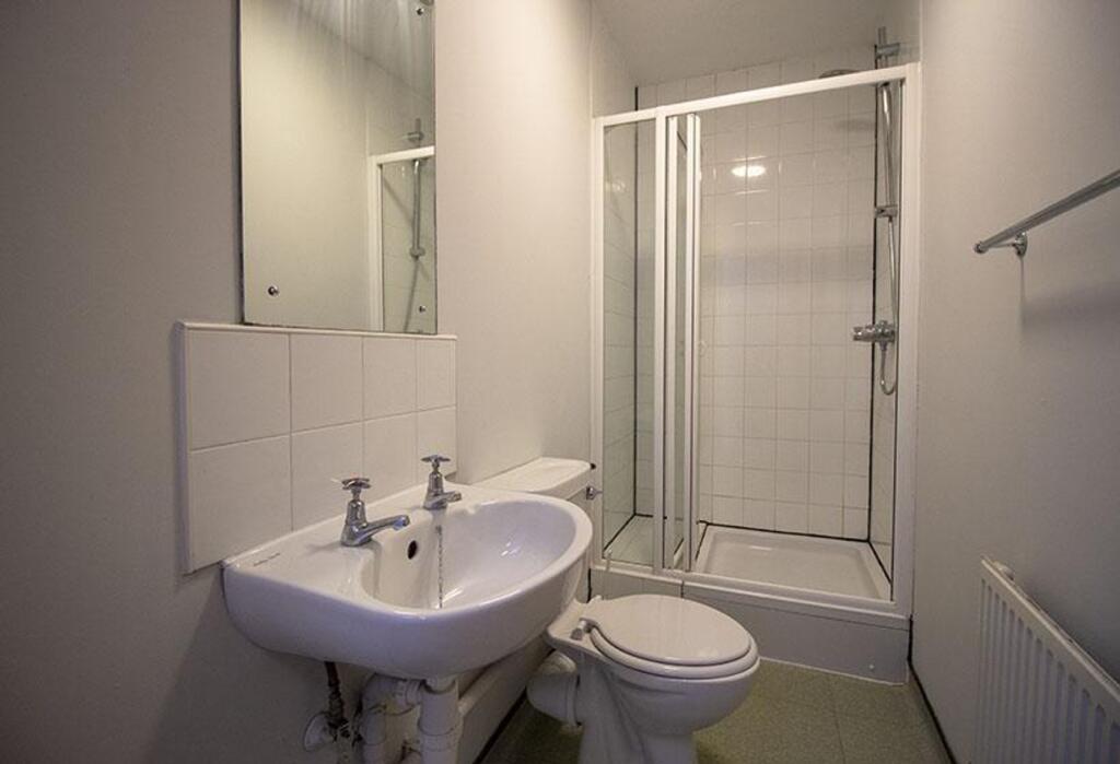 A well-maintained bathroom featuring a modern s...