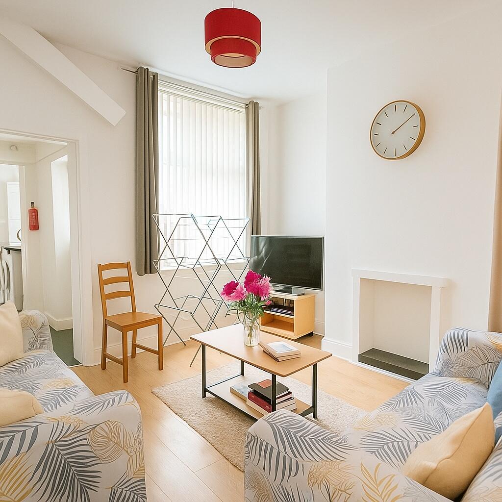 A bright and inviting living room featuring com...