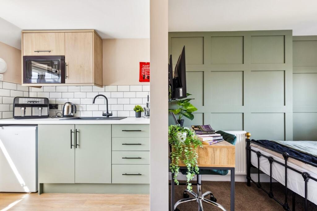 This stylish double bedroom features a cozy sle...