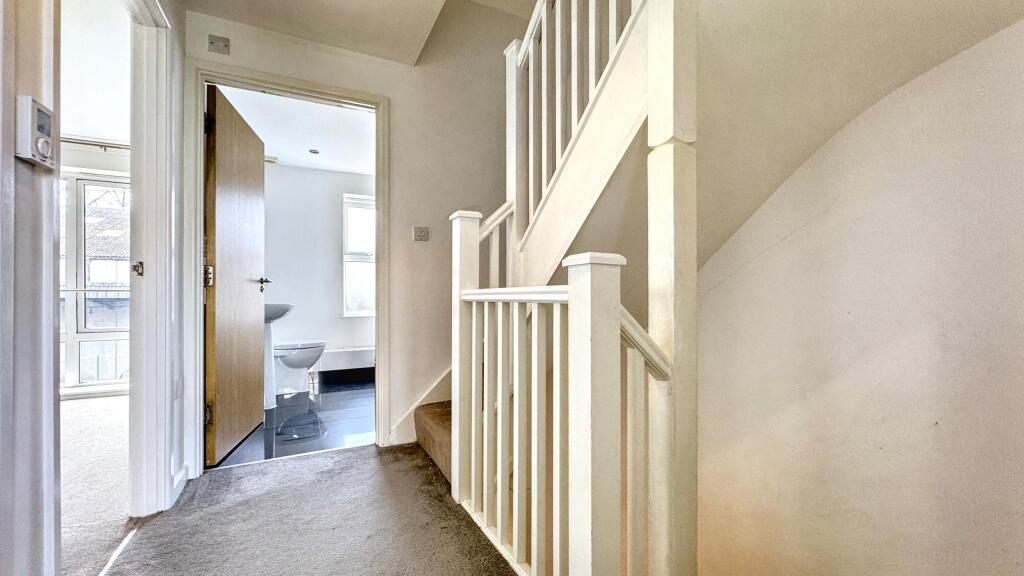 Bright and clean hallway with neutral walls and...
